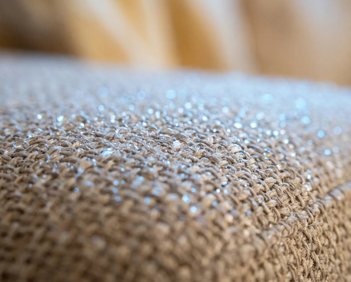 Fine mist droplets settling into couch fabric fibers